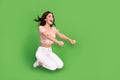 Full length photo of shiny excited lady wear print top smiling riding horse empty space isolated green color background Royalty Free Stock Photo