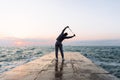 Full length photo of sportsman stretching with skipping rope, near the sea Royalty Free Stock Photo