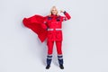 Full length photo of strong brave old woman work hero ambulance wear cape show muscle isolated on grey color background