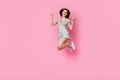 Full length photo of sweet cheerful girl dressed off shoulders outfit jumping high showing v-signs isolated pink color Royalty Free Stock Photo