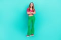 Full length photo of sweet pretty schoolgirl wear pink crop top flared pants arms crossed isolated turquoise color