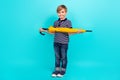 Full length photo of sweet small boy hold umbrella wear t-shirt jeans sneakers isolated on teal background Royalty Free Stock Photo