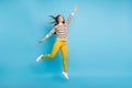 Full length photo of sweet woman dressed ornament pullover jumping empty space rising fist isolated blue color