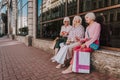 Three stylish female pensioners are sitting near mall Royalty Free Stock Photo