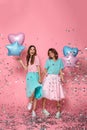 Full length photo of two happy beautiful girls with balloons celebrating birthday party Royalty Free Stock Photo