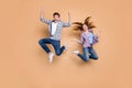 Full length photo of two people crazy lady guy jumping high overjoyed mood celebrate vacation summer beginning wear