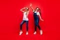 Full length photo of two pretty small ladies long tails rejoicing at school party best friends wear cool sun specs jeans Royalty Free Stock Photo