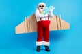 Full length photo of white grey hair bearded santa claus play water gun have wings x-mas christmas eve time noel travel Royalty Free Stock Photo