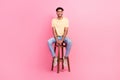 Full length photo of young applicant man wear t-shirt denim jeans sitting bartender chair waiting his turn  on Royalty Free Stock Photo