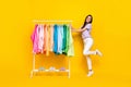 Full length photo of young attractive assistant shop expensive clothes sale choose isolated on yellow color background Royalty Free Stock Photo