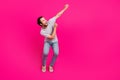Full length photo of young cheerful guy look empty space celebrate win lucky isolated over magenta color background