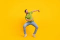 Full length photo of young cheerful man dance have fun clubber look empty space isolated over yellow color background Royalty Free Stock Photo