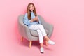 Full length photo of young chilling satisfied teenager schoolgirl chill couch with smartphone browsing information