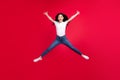 Full length photo of young excited asian girl happy positive smile jump star energetic isolated over red color Royalty Free Stock Photo