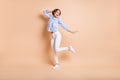 Full length photo of young excited girl happy positive smile have fun dance look empty space isolated over beige color Royalty Free Stock Photo
