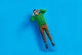 Full length photo of young funky guy jumping air hold his eyeglasses overjoyed having fun vision checkup isolated on