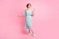 Full length photo of young girl happy positive smile have fun enjoy dance look empty space isolated over pastel color Royalty Free Stock Photo