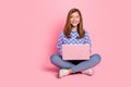 Full length photo of young girl sit floor use laptop dream idea look empty space isolated over pink color background