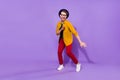 Full length photo of young guy happy positive smile funny clubber dancer isolated over purple color background Royalty Free Stock Photo