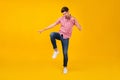 Full length photo of young man happy positive smile have fun dance party isolated over yellow color background Royalty Free Stock Photo