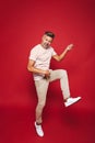 Full length photo of young man in striped t-shirt screaming and Royalty Free Stock Photo