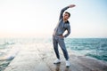 Healthy sportsman on workout, on pier, near the sea Royalty Free Stock Photo