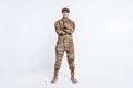 Full length photo of young woman confident crossed hands soldier officer army camouflage uniform isolated over white