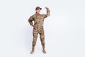 Full length photo of young woman soldier officer army show hand biceps power strong isolated over white color background Royalty Free Stock Photo