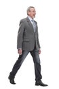 full length picture of a mid aged business man walking towards the camera and smiling. Royalty Free Stock Photo