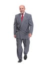 full length picture of a senior business man walking towards the camera and smiling. Royalty Free Stock Photo