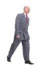 full length picture of a senior business man walking towards the camera and smiling. Royalty Free Stock Photo