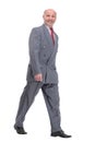 full length picture of a senior business man walking towards the camera and smiling. Royalty Free Stock Photo