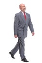 full length picture of a senior business man walking towards the camera and smiling. Royalty Free Stock Photo