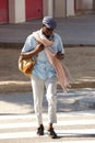 Full length African American man walking in the city with cell phone Royalty Free Stock Photo