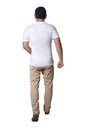 Full length portrait of Asian man wearing white shirt and khaki jeans standing walking, rear view Royalty Free Stock Photo
