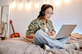 Teen Girl using Laptop in Bedroom Royalty Free Stock Photo