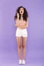 Full length portrait of astonished teenage girl with curly hair Royalty Free Stock Photo