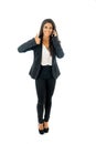 Full length portrait of Attractive latin corporate latin woman on her mobile excited and making thumb up sign in Creative success