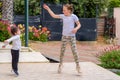 Full length portrait of attractive, playful, cheerful, happy comic couple children jumping over nature background. Royalty Free Stock Photo