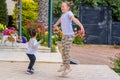 Full length portrait of attractive, playful, cheerful, happy comic couple children jumping over nature background. Royalty Free Stock Photo