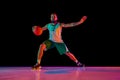 Full-length portrait of basketball player honing skills with precision dribbling and making powerful slam dunk against
