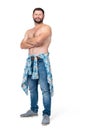Full length portrait of bearded smiling man in jeans and shirtless with his arms crossed, isolated on white background. Royalty Free Stock Photo