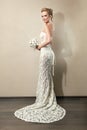 Full length portrait of a beautiful bride holding bouquet Royalty Free Stock Photo