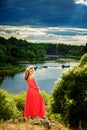 Full length portrait of beautiful sensual young blond woman near the lake outdoors in natural background. girl in long pink dress Royalty Free Stock Photo