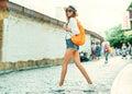 Full length portrait beautiful smilling tourist woman walking old town street, summer adventure vacation in Europe. Royalty Free Stock Photo