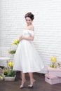 Full length portrait of a beautiful young bride in white dress with flowers in her hair Royalty Free Stock Photo