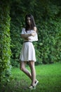 Full length portrait of a beautiful young caucasian woman in white dress with open shoulders, clean skin, long hair and casual Royalty Free Stock Photo