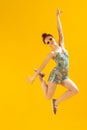 Full-length portrait of beautiful young girl posing isolated over yellow studio background. Summertime mood Royalty Free Stock Photo