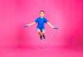 Full length portrait of boy jumping rope Royalty Free Stock Photo