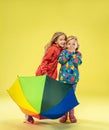 A full length portrait of a bright fashionable girls in a raincoat